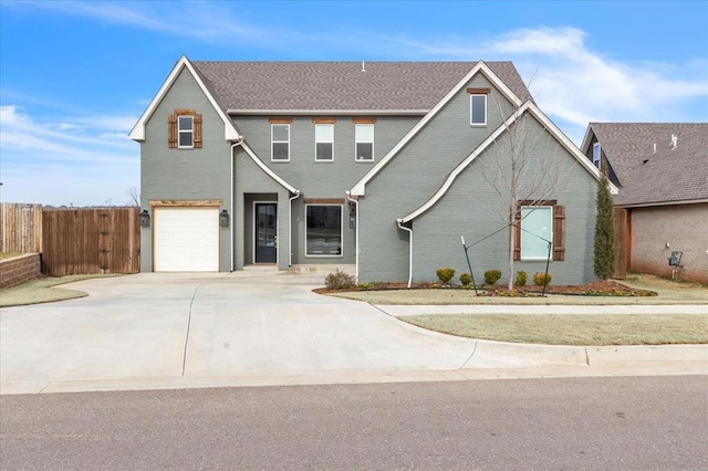 traditional-style house with brick siding, concrete driveway, a garage, and fence