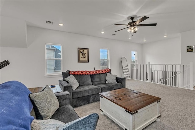 living area with recessed lighting, visible vents, a wealth of natural light, and ceiling fan