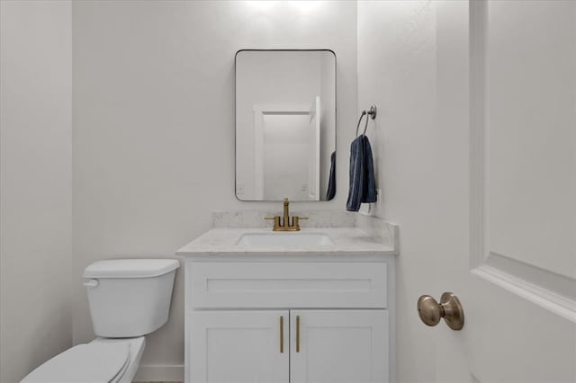 bathroom featuring toilet and vanity