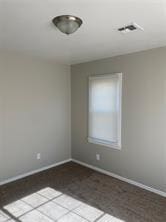 empty room featuring visible vents and baseboards