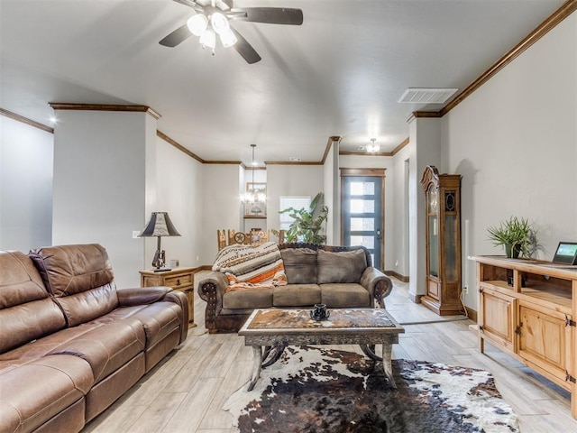 living area featuring crown molding, a ceiling fan, visible vents, and light wood-type flooring