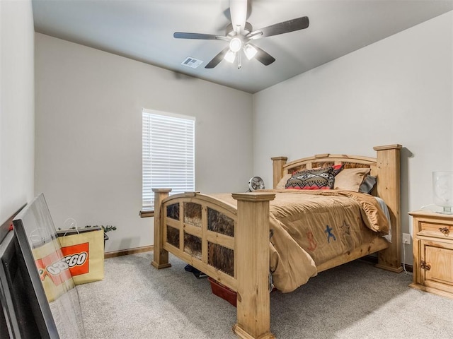 bedroom featuring visible vents, baseboards, light colored carpet, and a ceiling fan