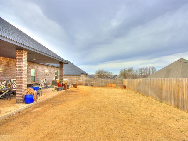 view of yard with a patio and a fenced backyard