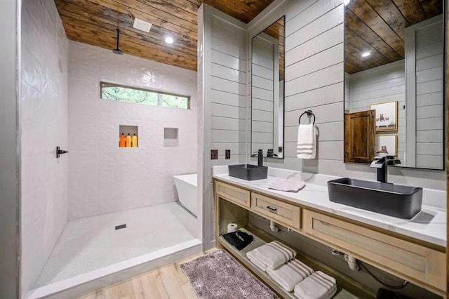 full bath featuring a sink, wood ceiling, double vanity, and a tile shower