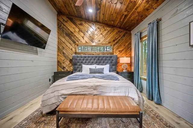 bedroom with wooden walls, wood ceiling, and wood finished floors