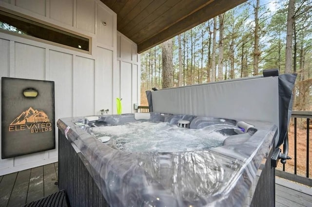 wooden deck with a hot tub