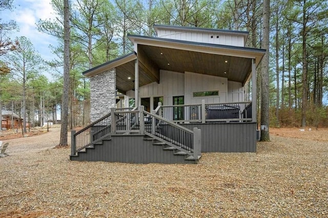 rear view of property featuring stairway and board and batten siding