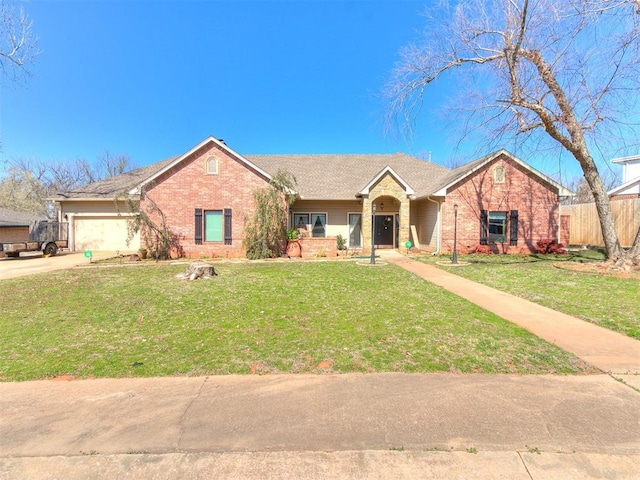 ranch-style home featuring brick siding, a garage, concrete driveway, and a front lawn