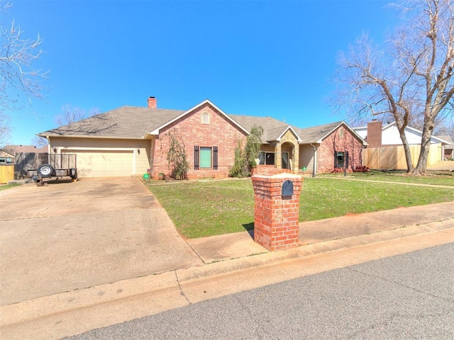 ranch-style home with brick siding, a garage, driveway, and a front yard