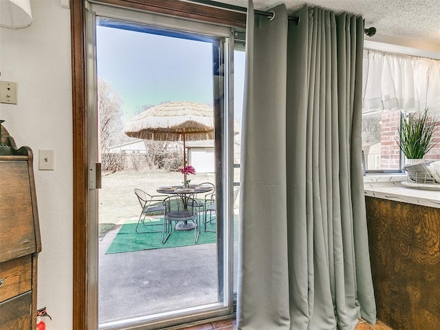 entryway with a textured ceiling