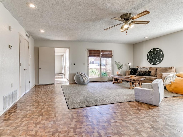 unfurnished living room featuring recessed lighting, a ceiling fan, visible vents, and a textured ceiling