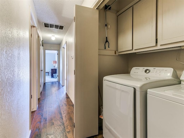 laundry room with visible vents, baseboards, dark wood-style flooring, a textured ceiling, and separate washer and dryer