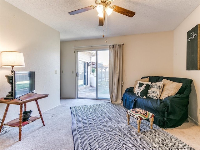 living room with baseboards, light colored carpet, a textured ceiling, and ceiling fan