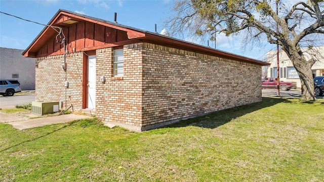 view of property exterior featuring brick siding and a lawn