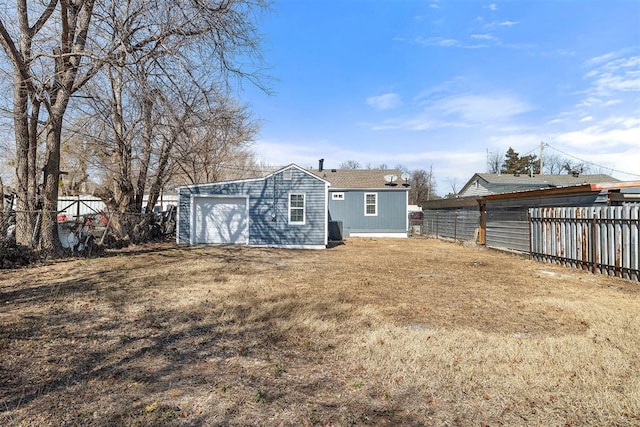 back of house with a garage and fence