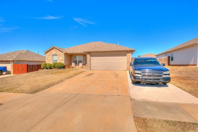 ranch-style home featuring driveway, a garage, and fence