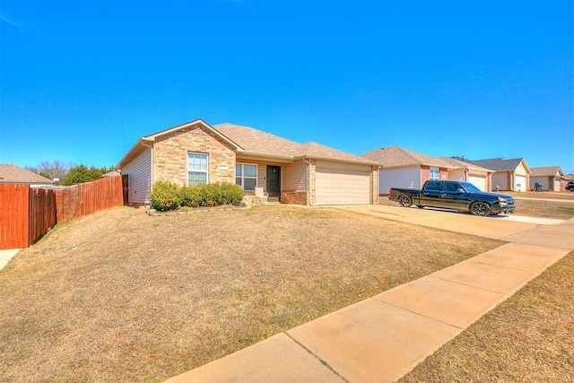 ranch-style house with fence, brick siding, a garage, and driveway