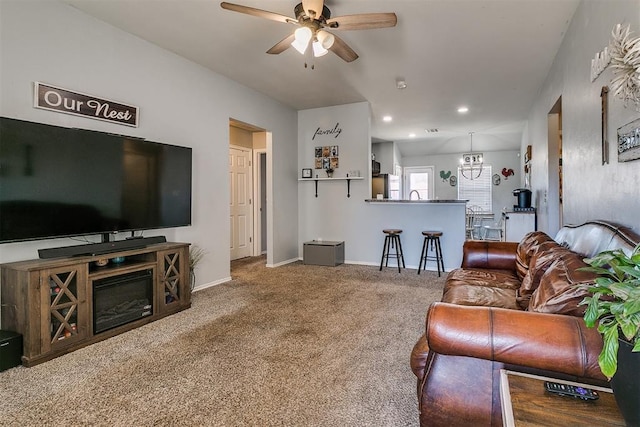 carpeted living area with a sink, recessed lighting, baseboards, and ceiling fan