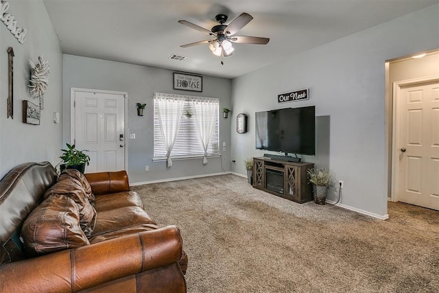 living room featuring carpet flooring, baseboards, visible vents, and ceiling fan