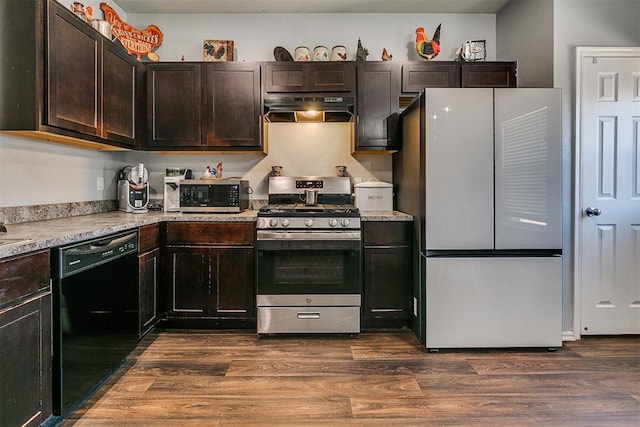 kitchen with dark brown cabinetry, dark wood-style flooring, under cabinet range hood, and stainless steel appliances