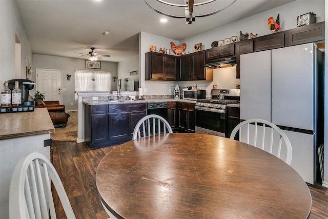 kitchen with ceiling fan, under cabinet range hood, gas range, black dishwasher, and freestanding refrigerator