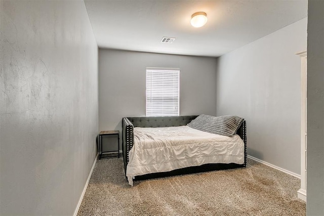 bedroom featuring visible vents, carpet, and baseboards