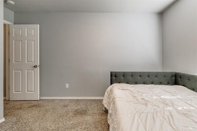 bedroom with carpet flooring and baseboards