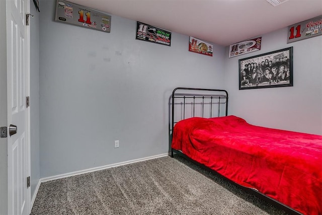 bedroom featuring baseboards and carpet