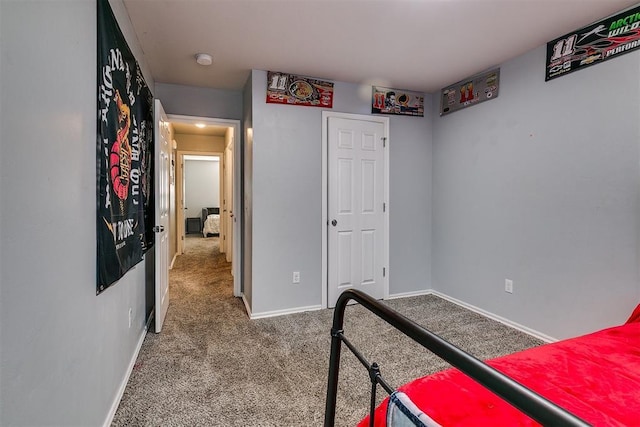 bedroom featuring carpet and baseboards