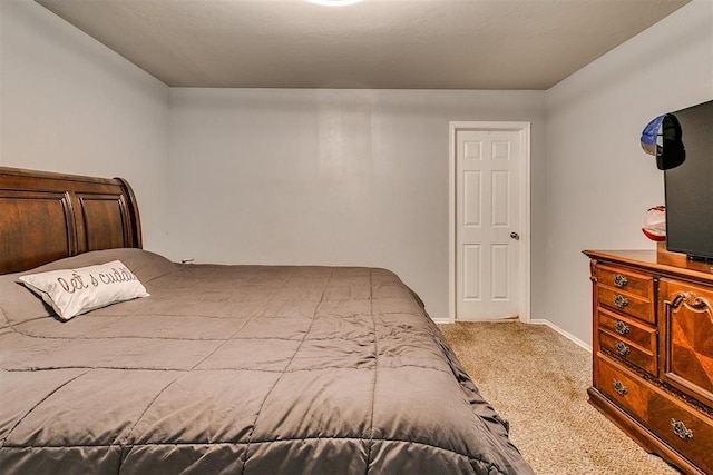 bedroom with baseboards and carpet floors