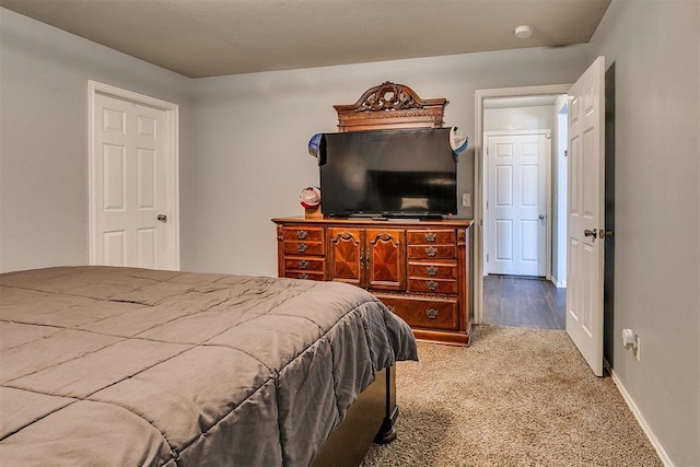 bedroom featuring baseboards and carpet floors