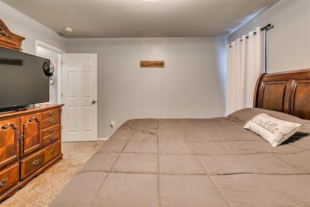 bedroom featuring light colored carpet