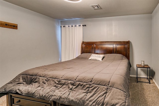 carpeted bedroom with baseboards and visible vents