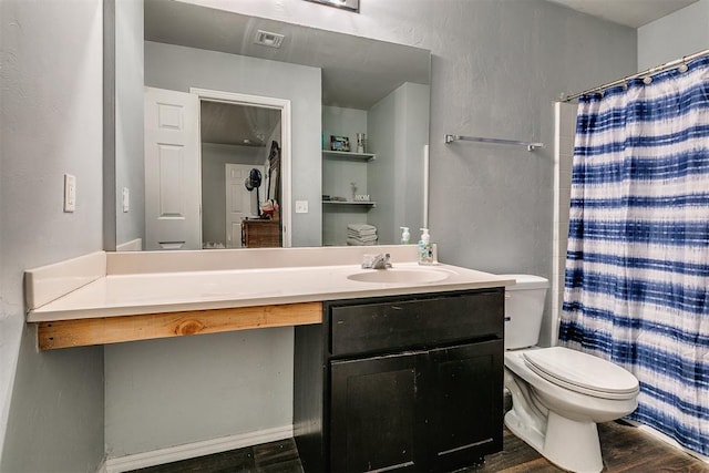 bathroom featuring visible vents, toilet, wood finished floors, a shower with shower curtain, and vanity