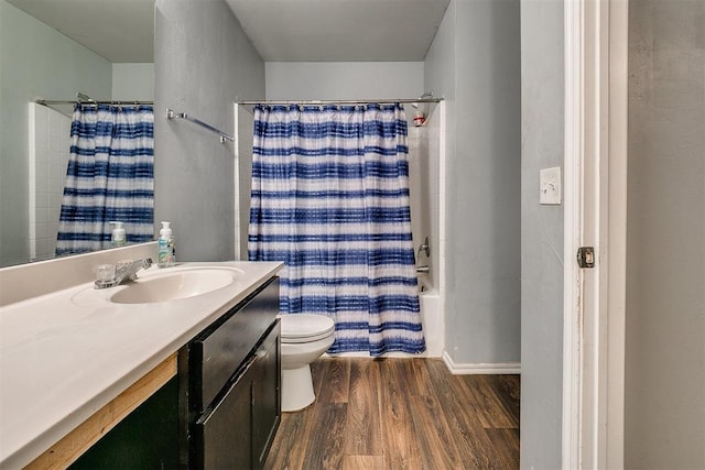 full bath with shower / bath combination with curtain, toilet, vanity, and wood finished floors