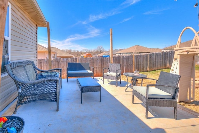 view of patio featuring an outdoor living space and a fenced backyard