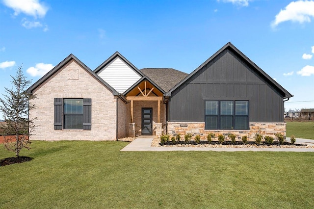 view of front of home with stone siding and a front yard