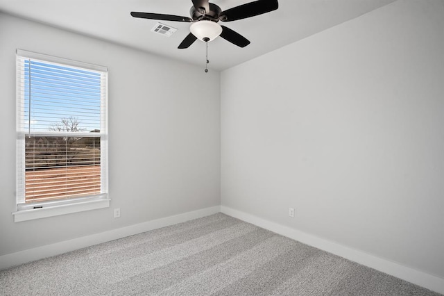 empty room with visible vents, a ceiling fan, baseboards, and carpet floors