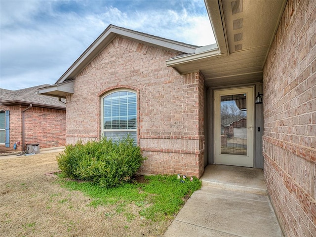 property entrance featuring brick siding