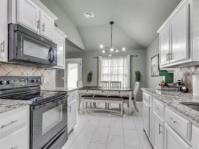 kitchen featuring visible vents, vaulted ceiling, white cabinets, black appliances, and marble finish floor