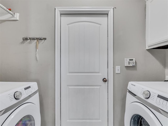 laundry room featuring cabinet space and washing machine and clothes dryer