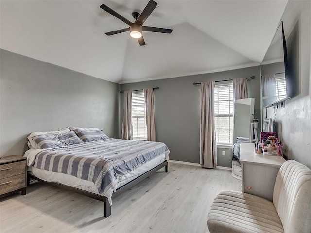 bedroom featuring vaulted ceiling, baseboards, light wood finished floors, and ceiling fan