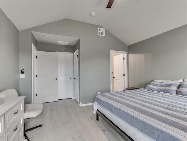 bedroom featuring visible vents, ceiling fan, light wood-type flooring, and lofted ceiling