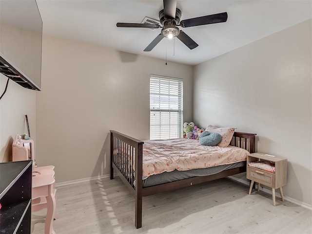 bedroom with baseboards, wood finished floors, and a ceiling fan