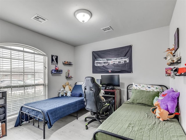 bedroom with wood finished floors and visible vents