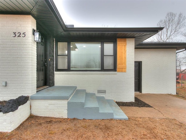 property entrance with brick siding