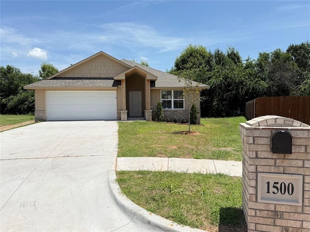 1500 Stirrup Way, Yukon, OK 73099 - view of front of home featuring driveway, an attached garage, a shingled roof, and brick siding
