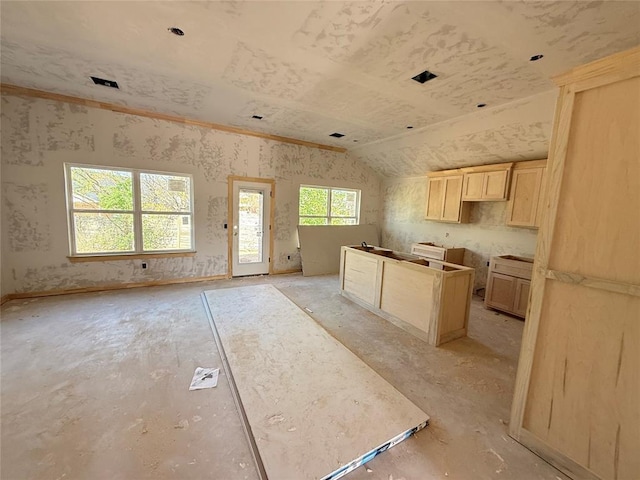 1500 Stirrup Way, Yukon, OK 73099 - kitchen with light brown cabinetry, lofted ceiling, and open floor plan