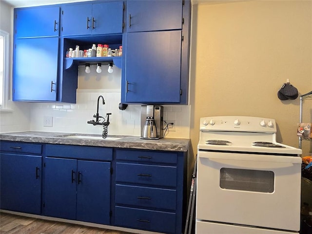 kitchen with white range with electric cooktop, blue cabinets, and a sink