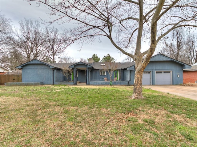 view of front of property featuring fence, driveway, a chimney, a front lawn, and brick siding